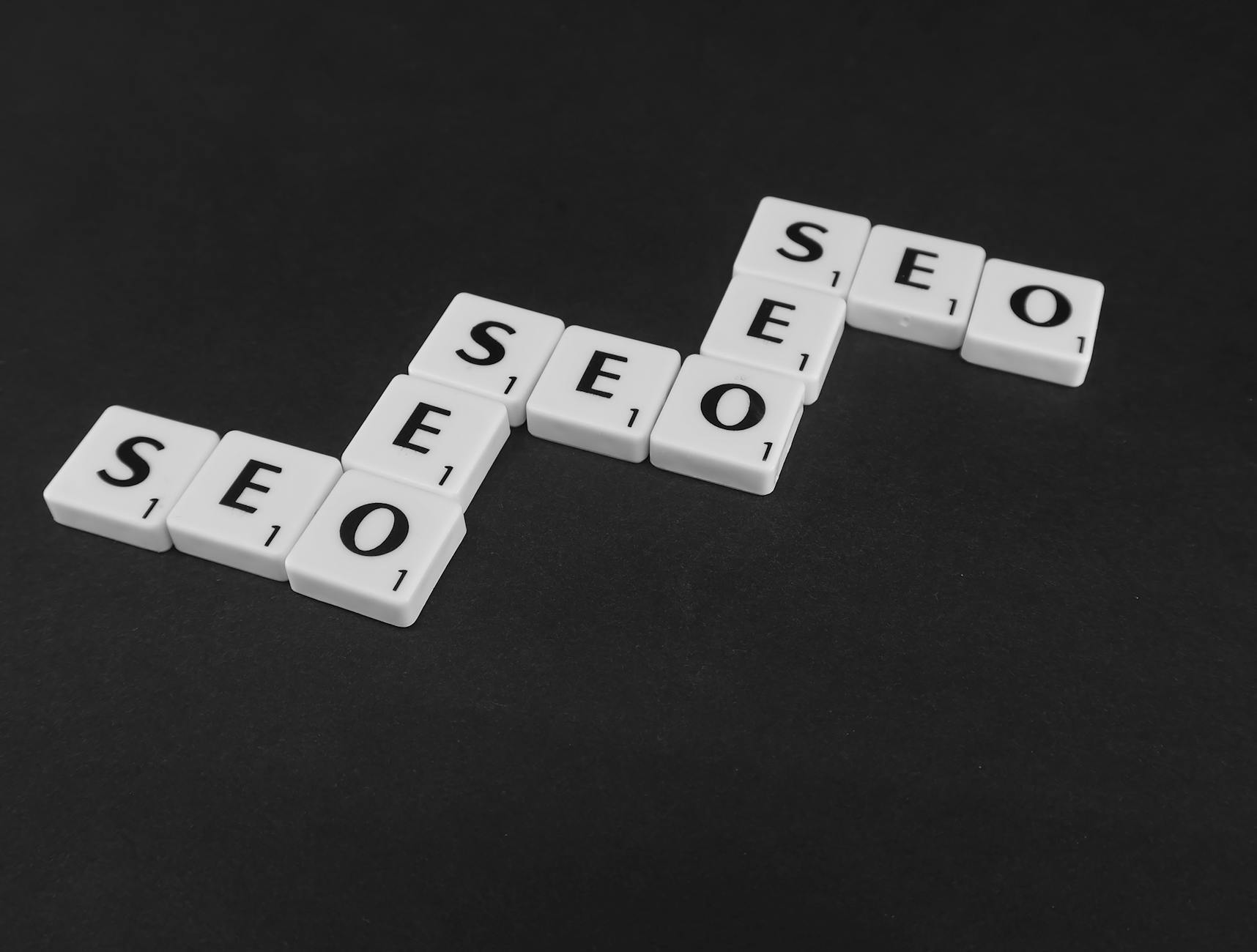 white scrabble tiles on a black surface